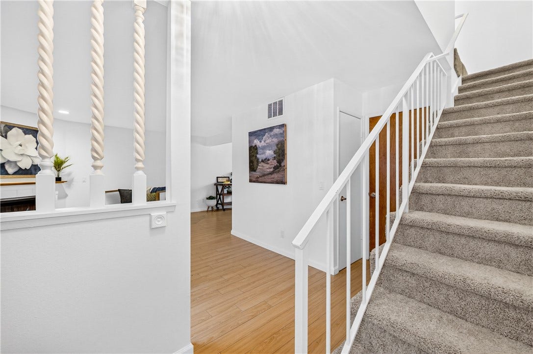 Bright upper-level landing provides an inviting transition between the main living spaces and bedrooms.