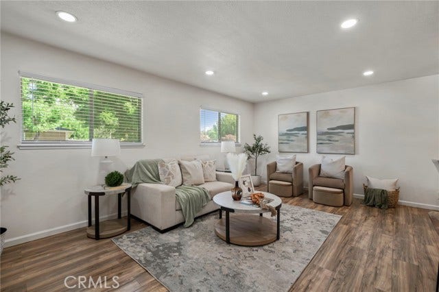 3125 N White AVE, #4, La Verne, CA 91750 Bright and inviting living room featuring abundant natural light, recessed lighting and warm wood-look flooring.