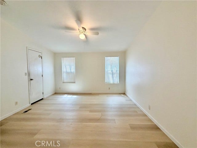 wide masterdom view highlighting natural light and generous floor space.