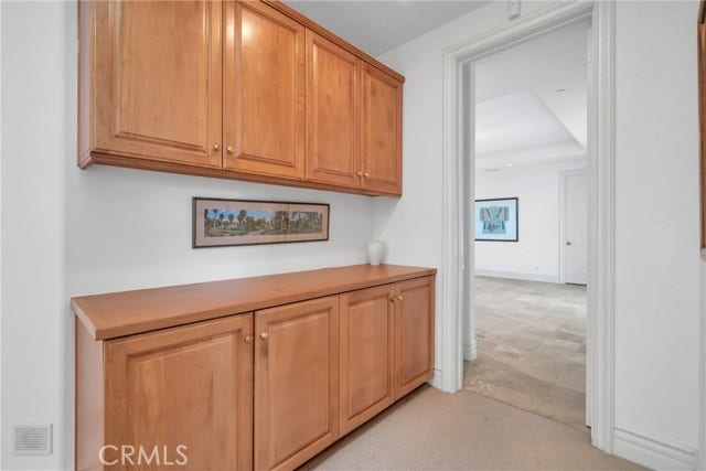 Built-in cabinetry offers great storage at top of stair landing.