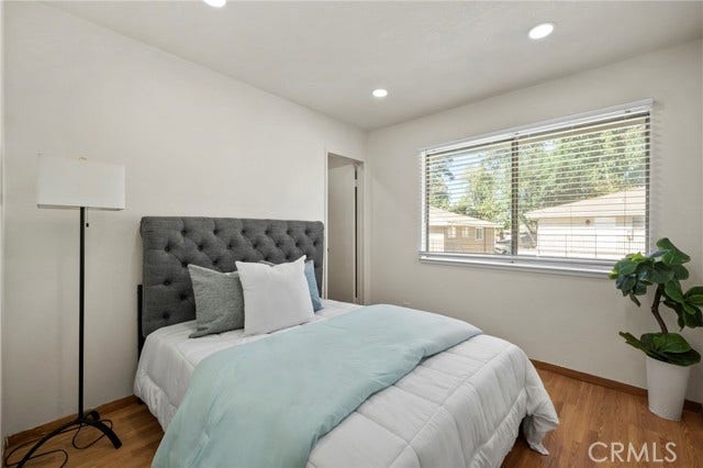 3125 N White AVE, #4, La Verne, CA 91750 Bright second bedroom featuring wood flooring, recessed lighting and a large window providing plenty of natural light.