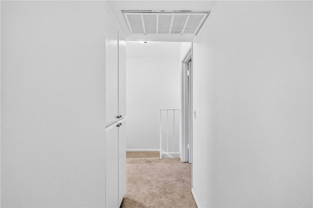 Bright hallway provides convenient access to the private bedroom level.