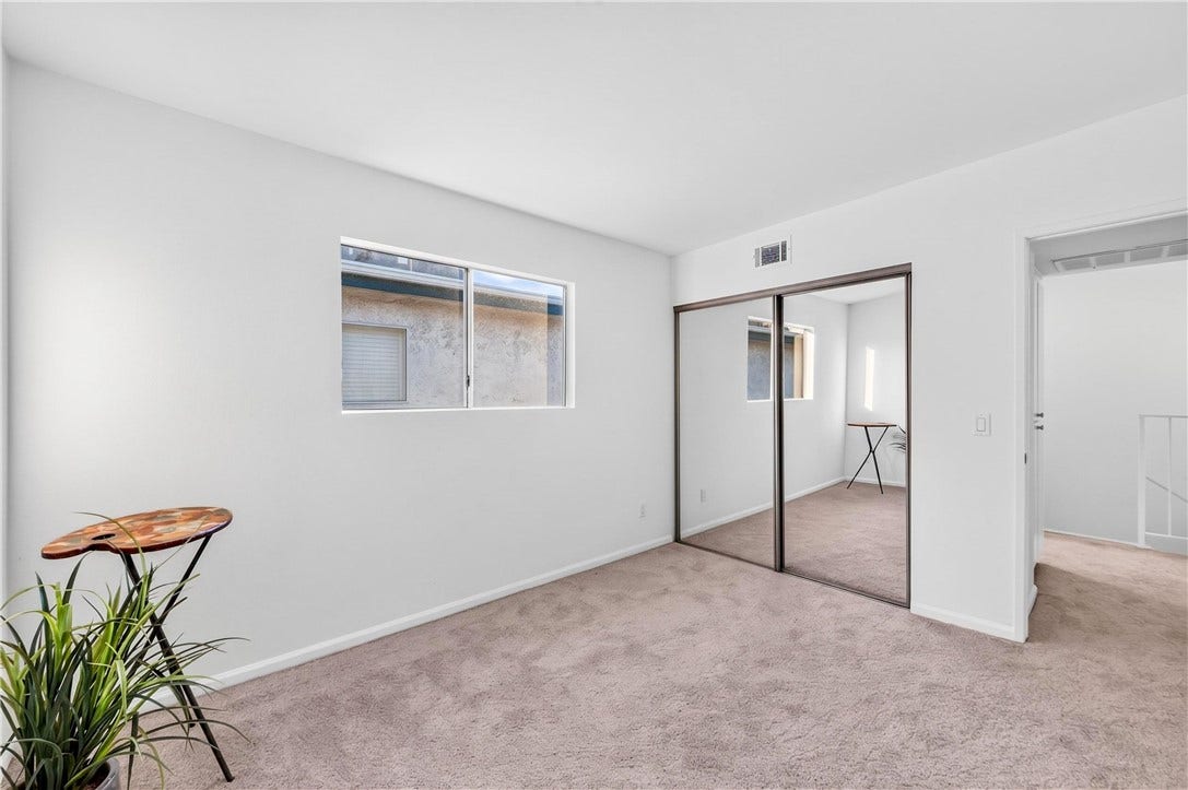 Generously sized bedroom offers flexible furnishing options and a bright, airy atmosphere.