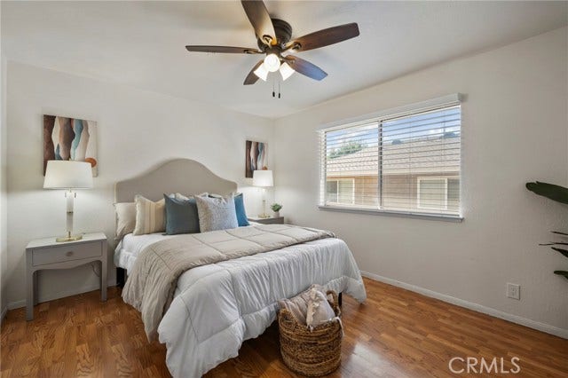 3125 N White AVE, #4, La Verne, CA 91750 Bright and spacious primary bedroom featuring beautiful wood flooring, ceiling fan and abundant natural light.
