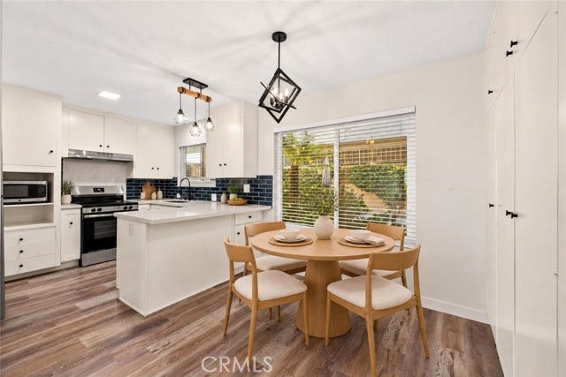 Remodeled kitchen, new quartz counters, appliances, lighting, tile backsplash. (Virtual stage)