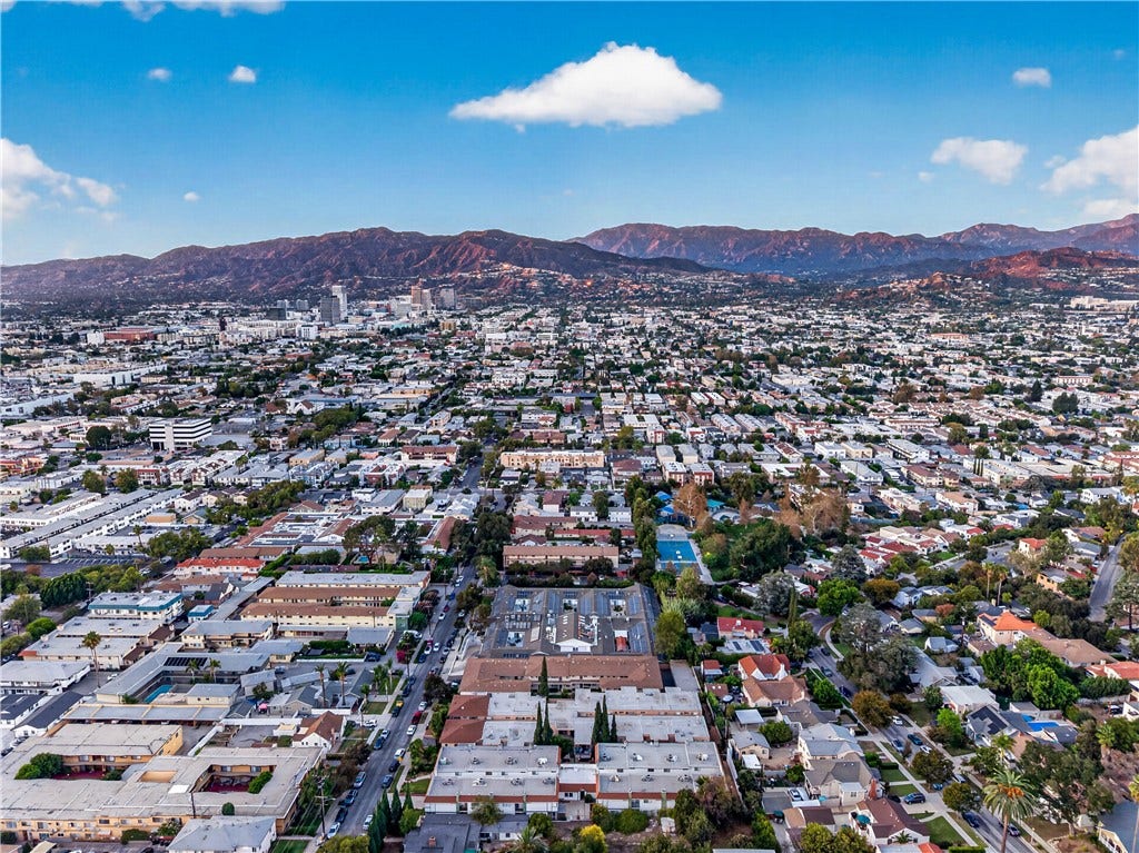 Sweeping aerial view showcases Glendale s established neighborhoods and dramatic mountain backdrop.