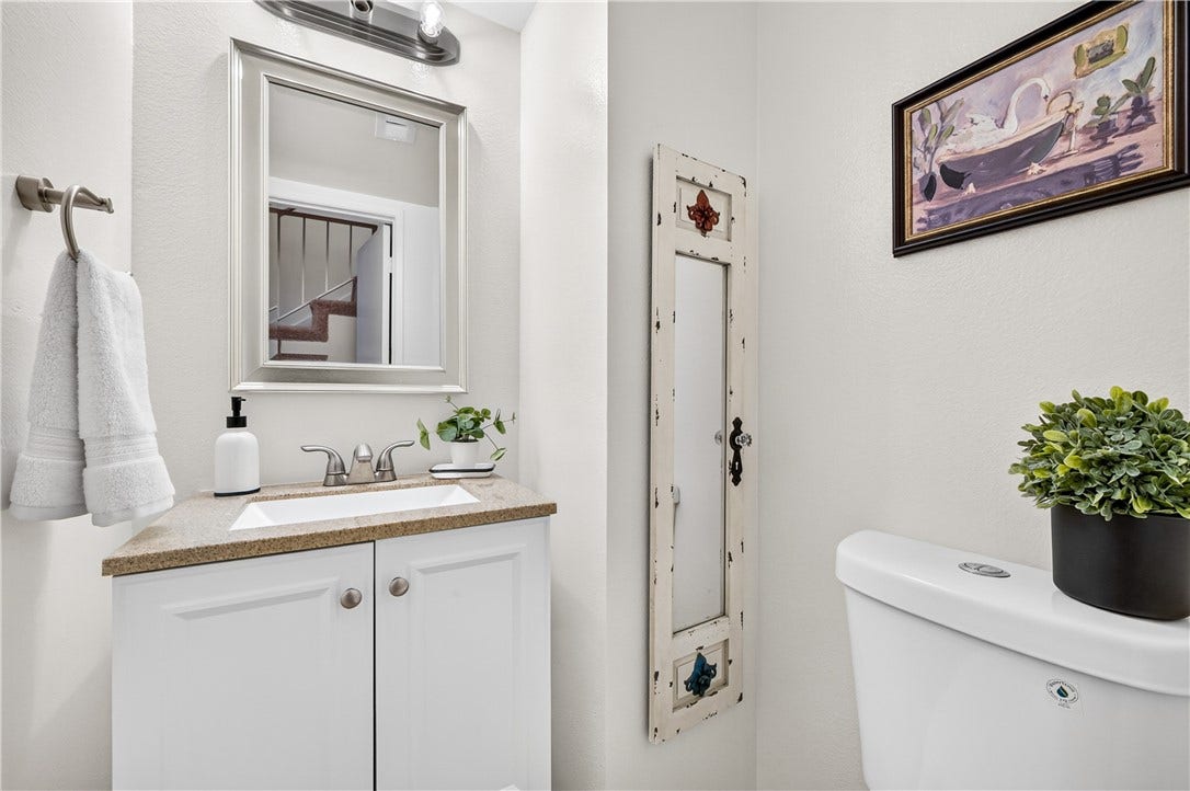 Convenient powder room features a clean, contemporary presentation and generous vanity storage.