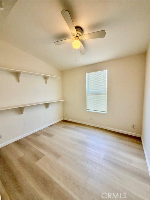 additional bedroom view featuring lightened flooring and a ceiling fan.