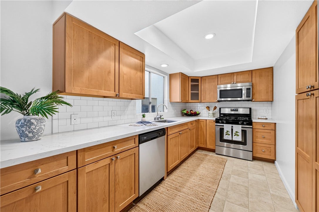 Generous cabinetry and expansive counter space provide excellent storage and preparation areas.