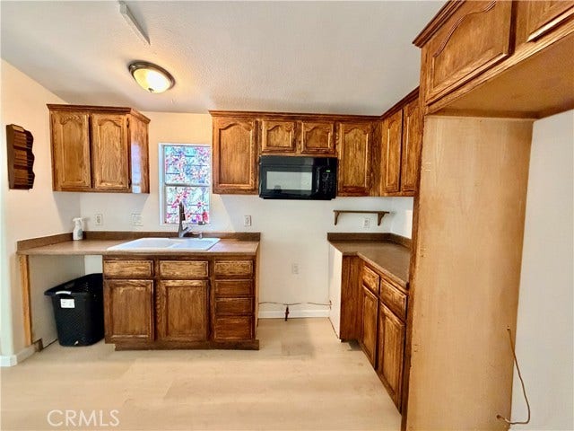 additional kitchen view highlighting cabinet storage and the cooking area.