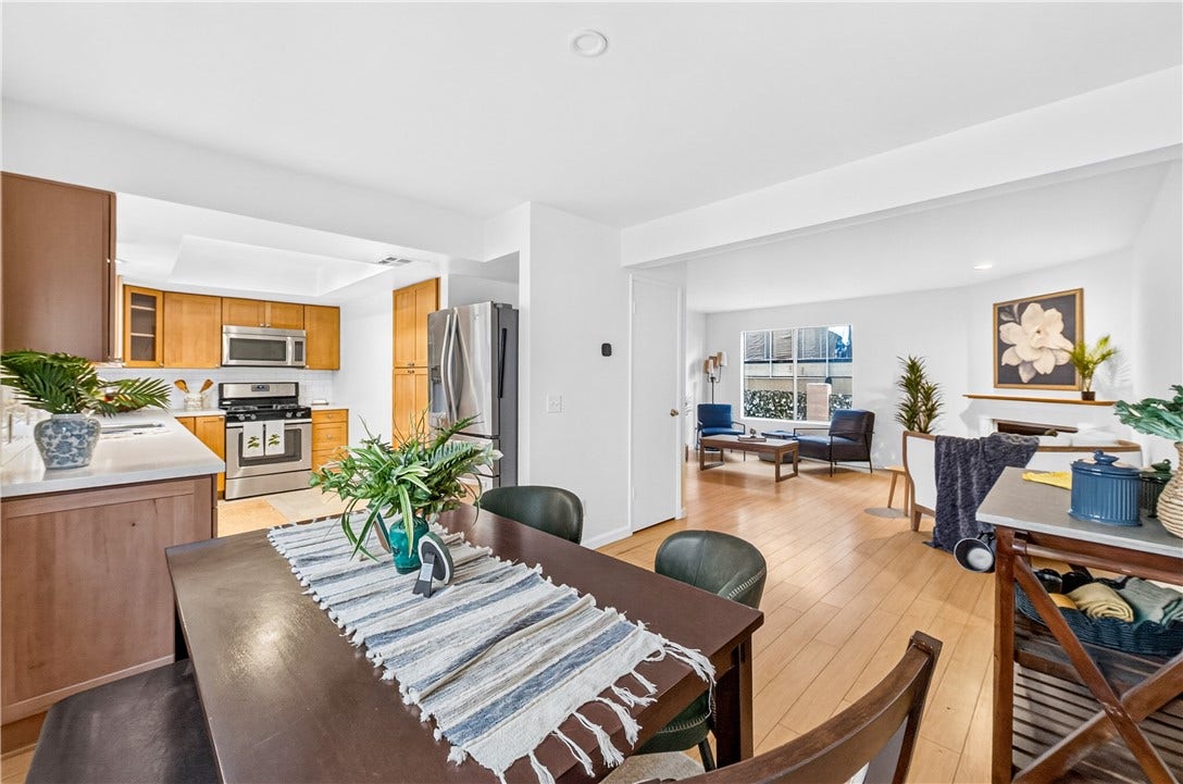 The kitchen opens to the dining area and living room for a connected, functional layout.