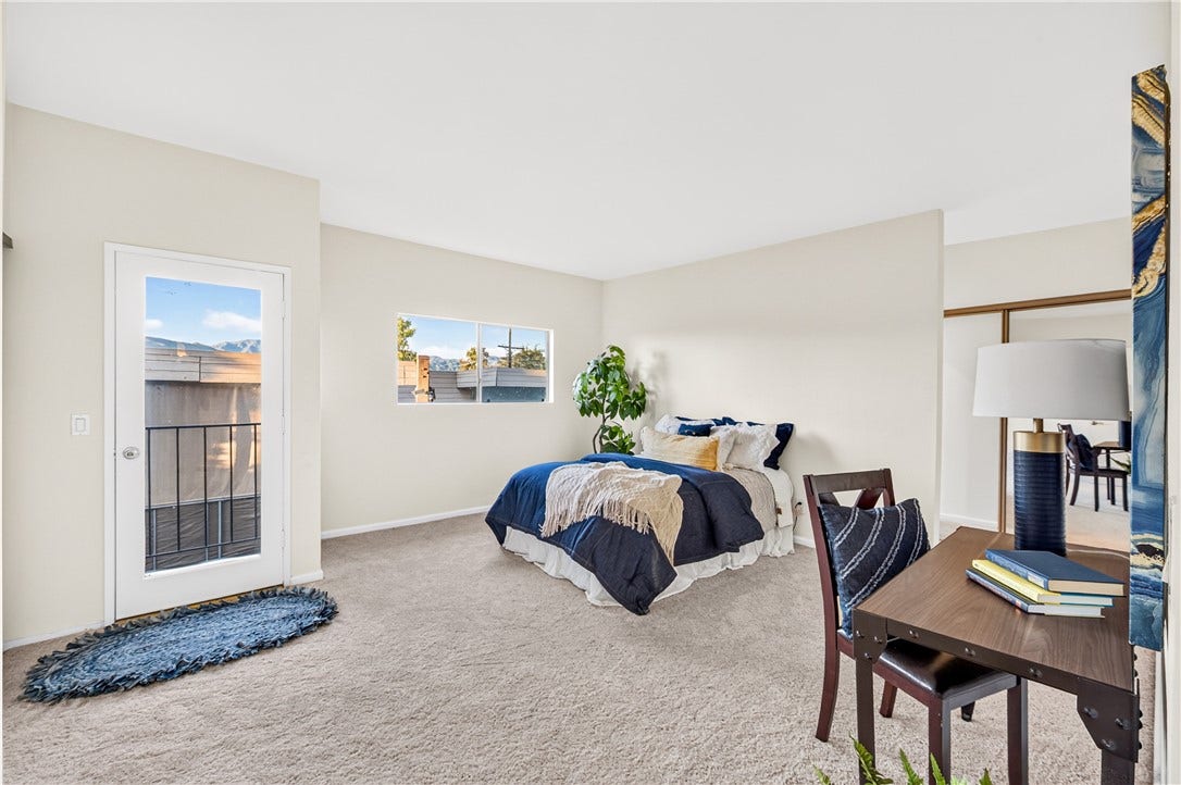 Spacious bedroom offers plush carpeting, natural light, and a flexible layout.