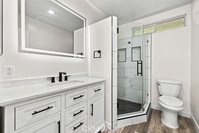 Remodeled primary suite bathroom with walk in shower