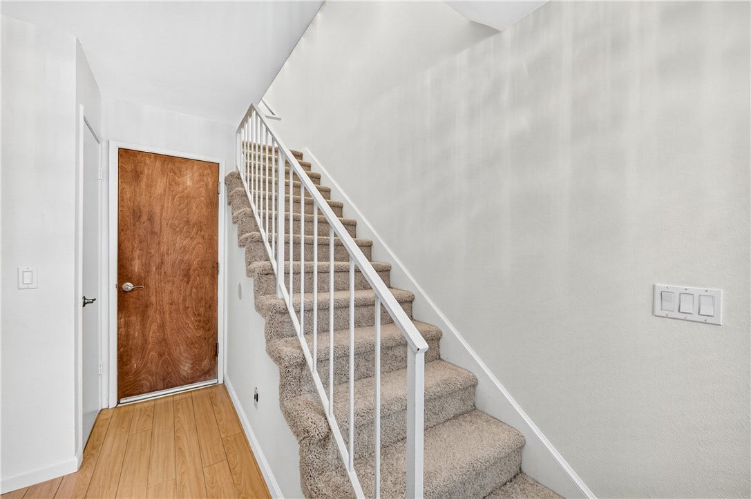 Interior staircase connects the living level with the private bedroom quarters above.