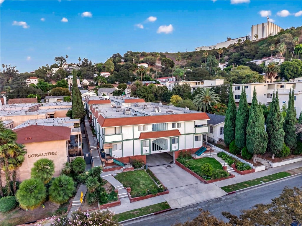 Elevated perspective showcases the attractive architecture, landscaped grounds, and surrounding neighborhood.