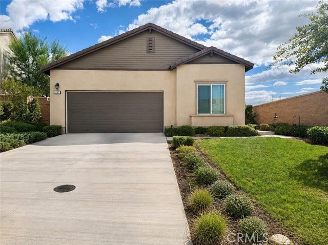 digitally altered image added greenery by driveway