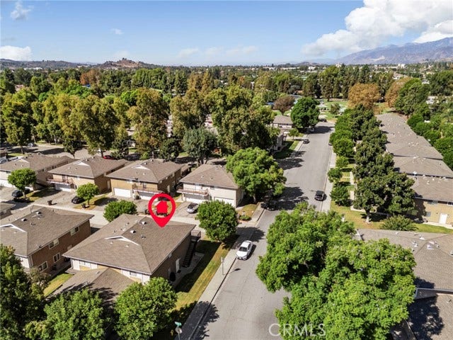 3125 N White AVE, #4, La Verne, CA 91750 Aerial view of the La Verne community, surrounded by mature trees with beautiful mountain views in the distance.