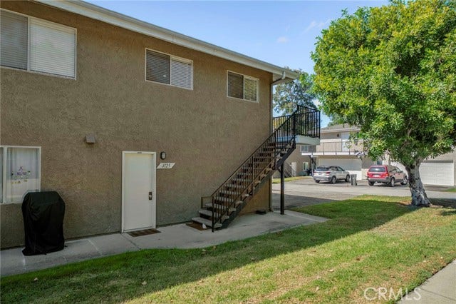 3125 N White AVE, #4, La Verne, CA 91750 Upstairs residence with stairway access, surrounded by mature trees and well-maintained community grounds.