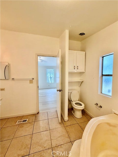 additional masterroom's bathroom view showing the vanity and bathtub area.