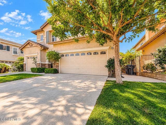Sunlit Suburban Home and Tree-Shaded Dri